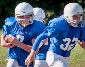 kids playing football wearing mouth guards | Newton Village Dental Clinic in Surrey